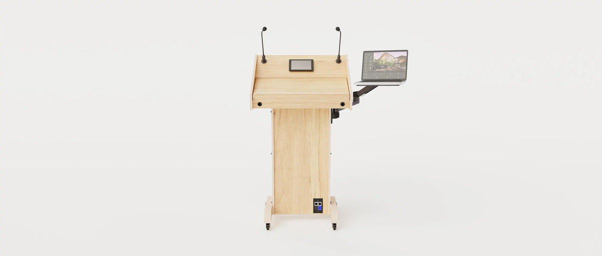 Wide angle front view of Lectern 1. Showing gooseneck mics, touch screen controller, laptop arm and tray, lower audio visual connection plate. Natural grain with expressed plywood edge.