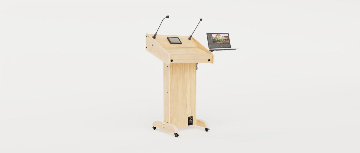 Wide angle right view of Lectern 1. Showing gooseneck mics, touch screen controller, laptop arm and tray, lower audio visual connection plate. Natural grain with expressed plywood edge.