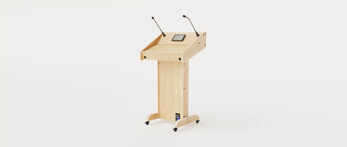 Wide angle right view of Lectern 1. Showing gooseneck mics, touch screen controller, lower audio visual connection plate. Natural grain with expressed plywood edge.