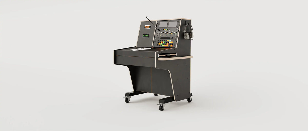 Wide angle view of the custom Stage Management Console model 1A with 10 rack units above the worktop, double door cabinet, a large drawer, steel legs with 80mm wheels. Black with expressed plywood edge.