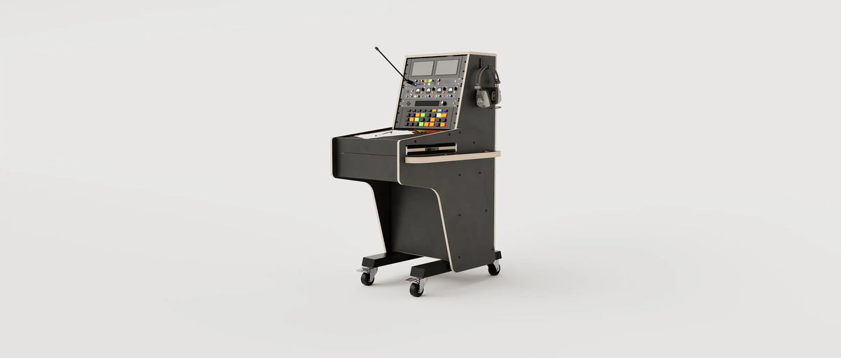Wide angle view of the custom Stage Management Console model 3A with 10 rack units above the worktop, single door cabinet, a large drawer, steel legs with 80mm wheels. Black with expressed plywood edge.